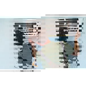 tech checking the AC unit filters