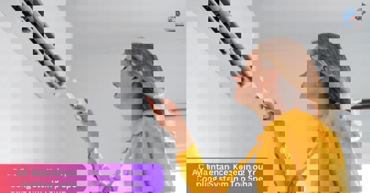 Woman standing beside a split-type AC with a remote.