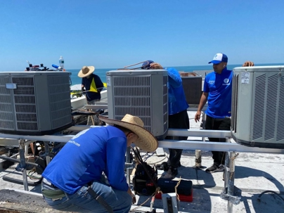 tech checking the ac units