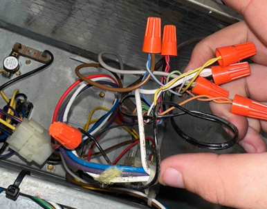 multiple wires connected using orange wire nuts.