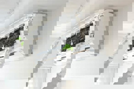 A technician opening an AC unit