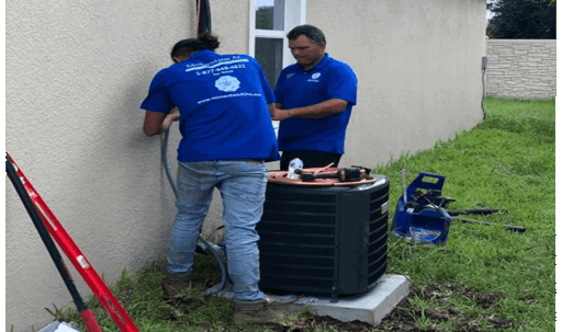 technician inspecting the outdoor units