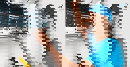 tech checking the AC unit filters