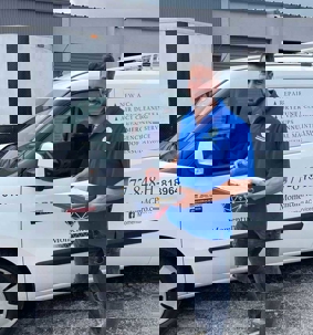 Technician beside his service vehicle.