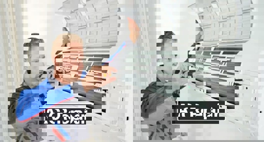 An AC repair technician is shown working on a wall-mounted air conditioner