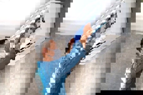 tech checking the AC unit filters