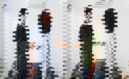 A man and a woman talking happily infront of an AC unit