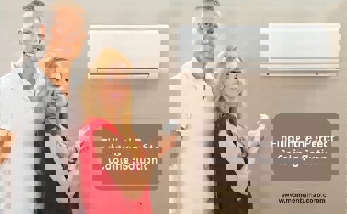 Couple standing beside a split-type AC with a remote.