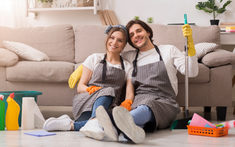 a couple enjoying cleaning their living room