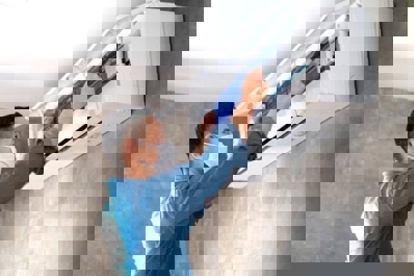 tech checking the AC unit filters