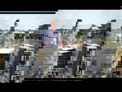 A technician checking the outdoor units