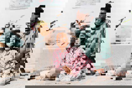 Father and daughter on the living room carpet.