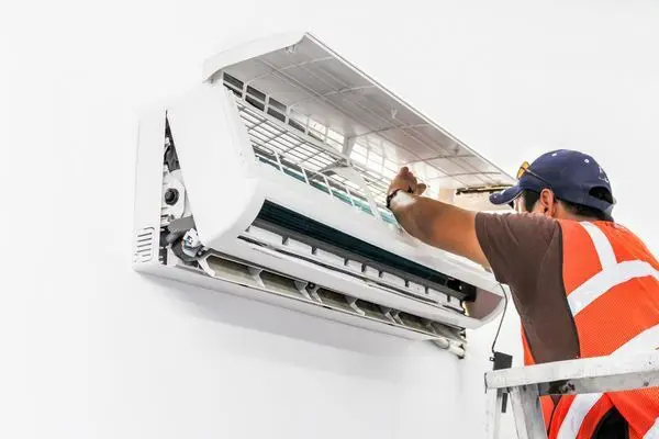 A technician doing an AC maintenance
